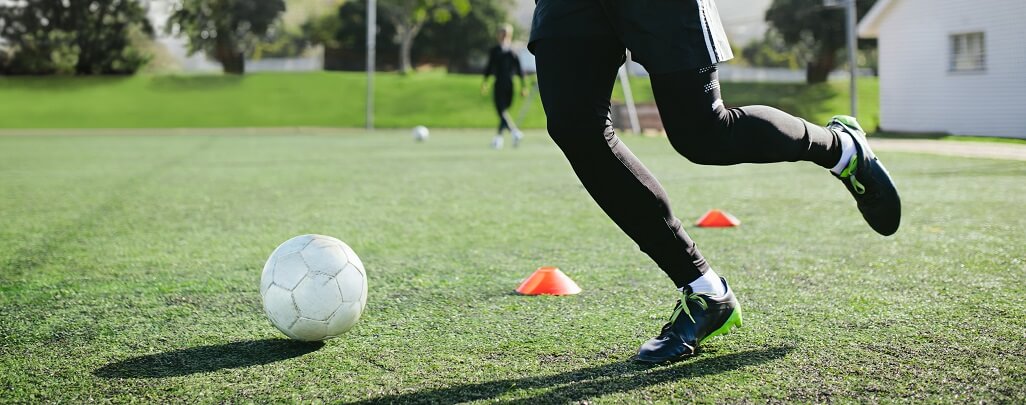 Leg skill training on football field. 